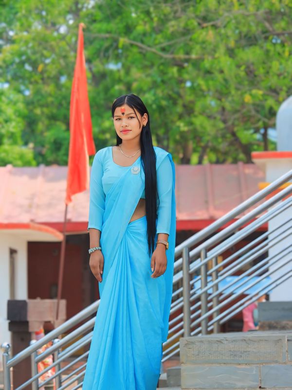 A young woman in traditional dress at a haveli gate